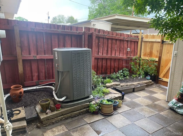 view of patio with fence and cooling unit