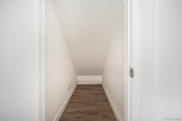 interior space featuring baseboards and wood finished floors