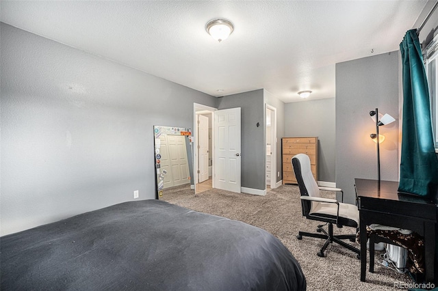 carpeted bedroom with a textured ceiling and baseboards