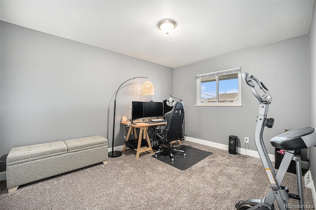 carpeted home office featuring baseboards and a textured ceiling