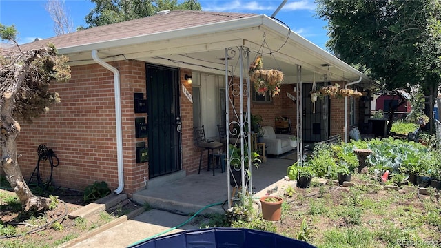 view of exterior entry featuring a patio