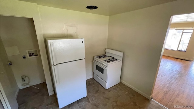 kitchen with white appliances and dark hardwood / wood-style floors