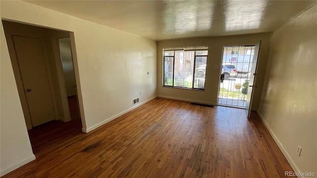 unfurnished room featuring dark hardwood / wood-style floors