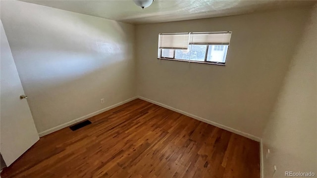 unfurnished room featuring wood-type flooring