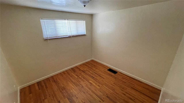 spare room with wood-type flooring