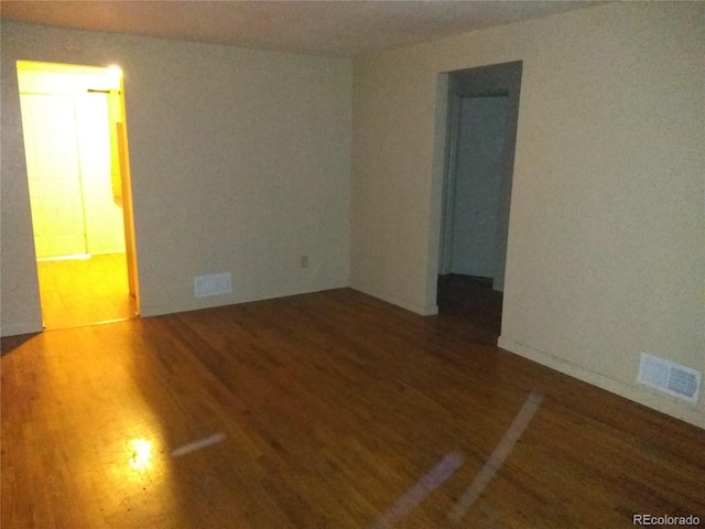 spare room featuring dark hardwood / wood-style flooring