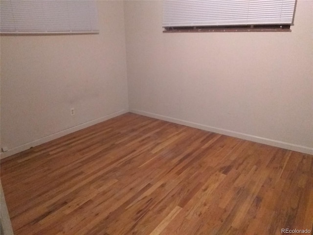 empty room with hardwood / wood-style floors