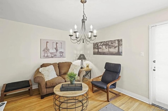 6235 E 6th Avenue Parkway, Denver, CO 80220 - living area featuring a notable chandelier, baseboards, and light wood-style floors