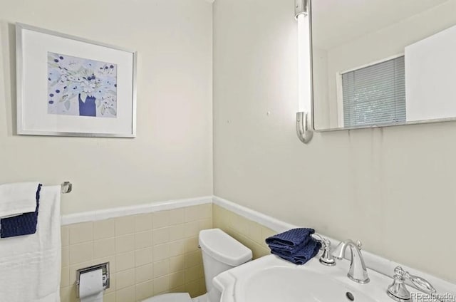 6235 E 6th Avenue Parkway, Denver, CO 80220 - half bath with toilet, tile walls, a wainscoted wall, and a sink