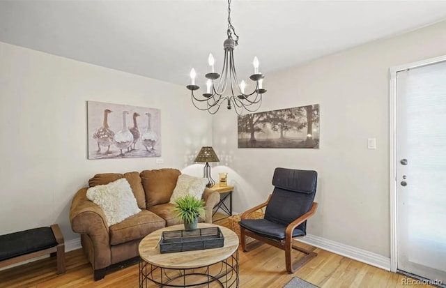 6235 E 6th Avenue Parkway, Denver, CO 80220 - living room featuring light wood-type flooring, baseboards, and a notable chandelier