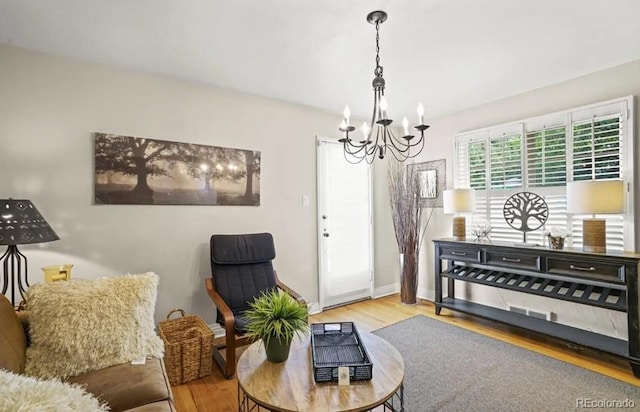 6235 E 6th Avenue Parkway, Denver, CO 80220 - living area with baseboards, a notable chandelier, and wood finished floors