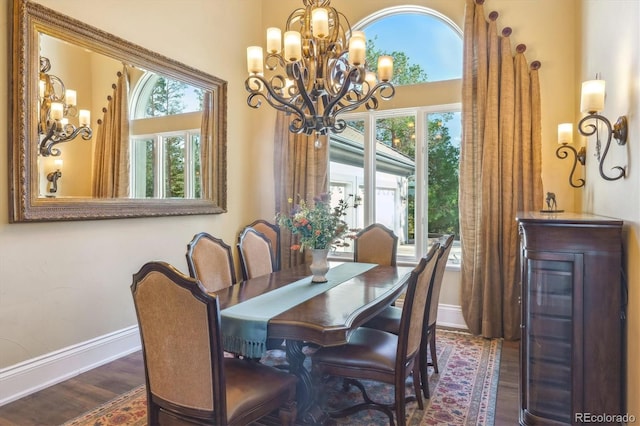 dining room with dark hardwood / wood-style floors and a chandelier