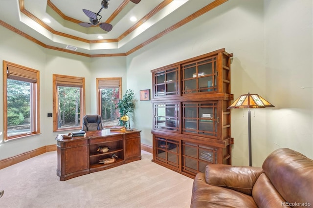 carpeted home office featuring a tray ceiling, ceiling fan, and crown molding