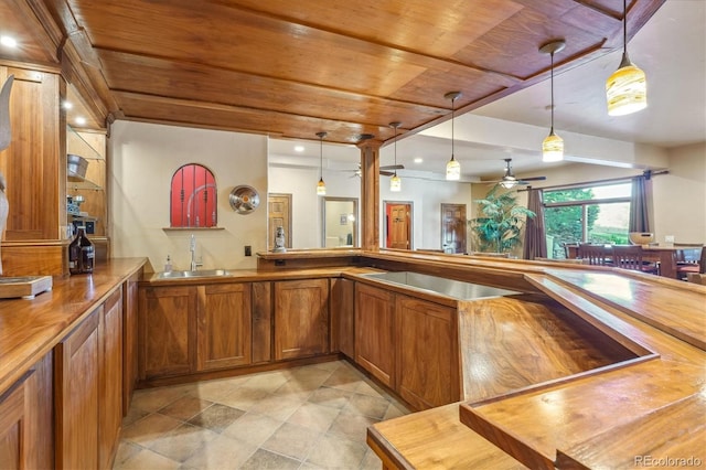 bar with sink, wooden ceiling, ceiling fan, wood counters, and decorative light fixtures