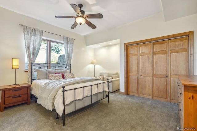 bedroom featuring ceiling fan, a closet, and light colored carpet