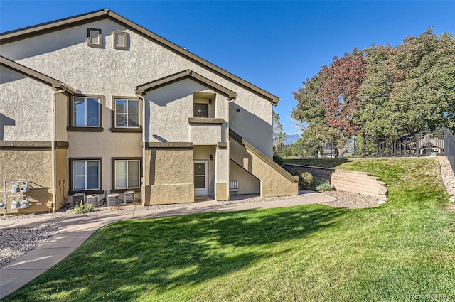 back of property featuring a lawn