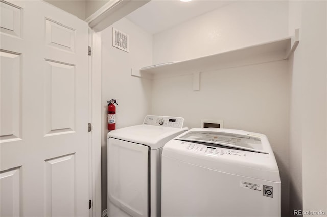 clothes washing area with washing machine and clothes dryer