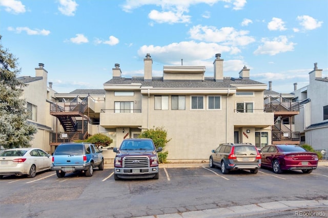 1845 Kendall St Unit 325D, Denver, CO 80214 - view of building exterior featuring stairway, uncovered parking, and a residential view