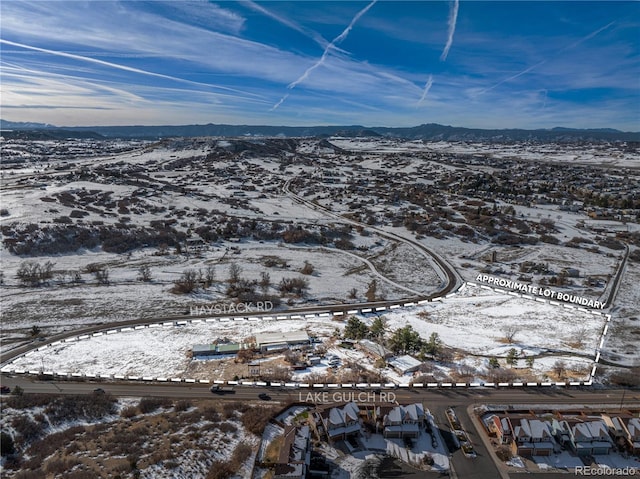 snowy aerial view with a mountain view