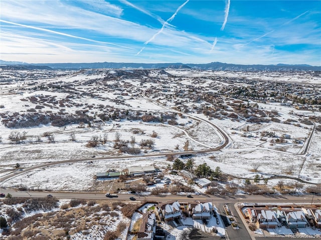 snowy aerial view featuring a mountain view