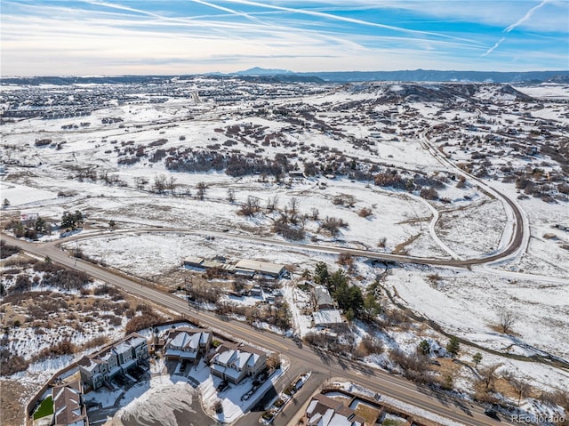 snowy aerial view featuring a mountain view