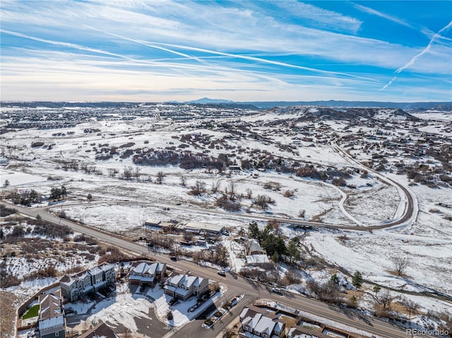 snowy aerial view featuring a mountain view