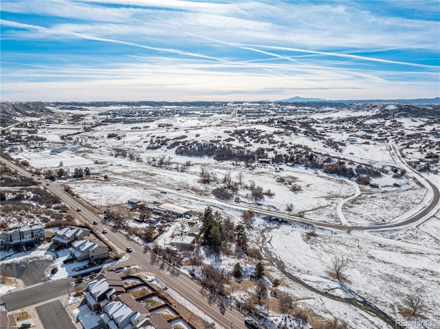 snowy aerial view with a mountain view