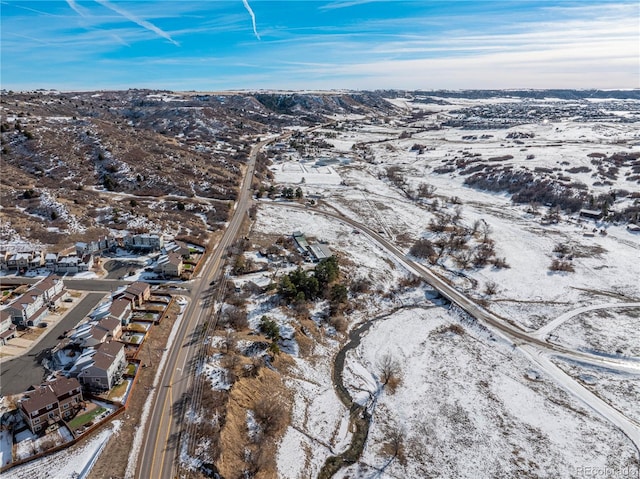 snowy aerial view with a mountain view