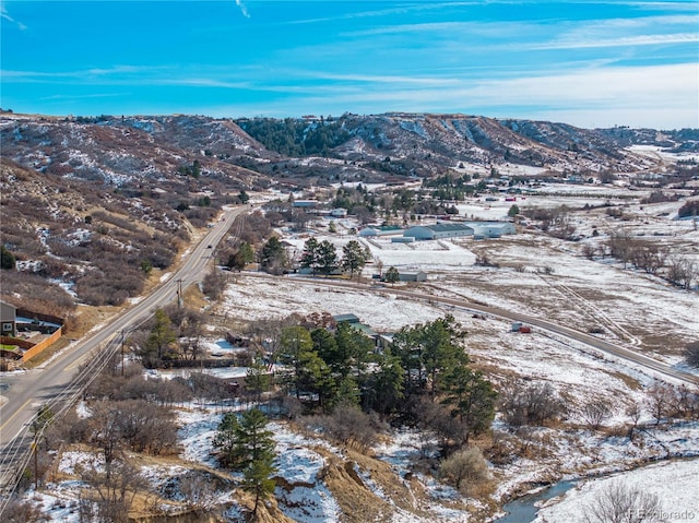 snowy aerial view with a mountain view