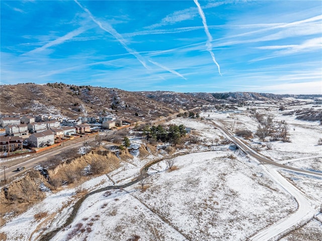 snowy aerial view with a mountain view