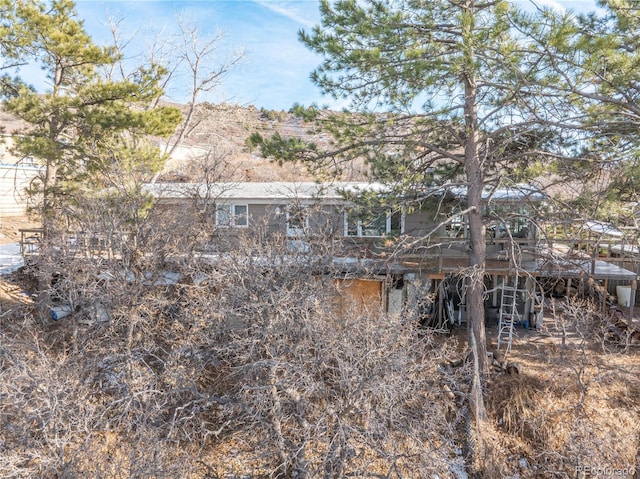 back of property with a wooden deck