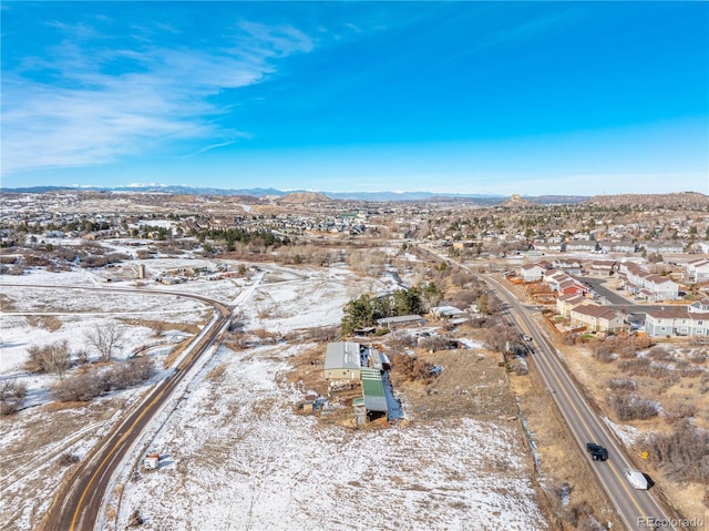 snowy aerial view featuring a mountain view