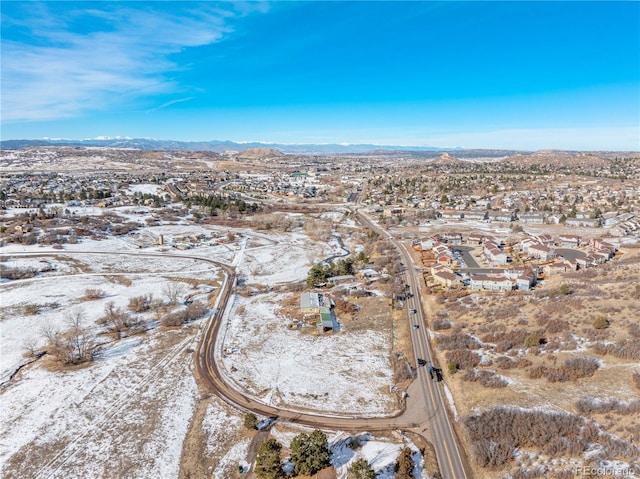 snowy aerial view with a mountain view