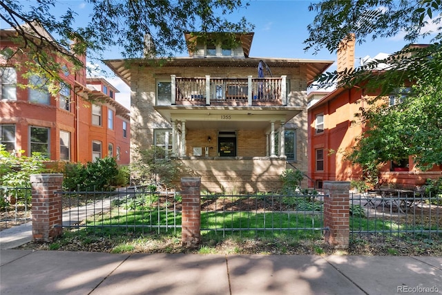 1355 N Franklin St Unit 5, Denver, CO 80218 - american foursquare style home with a balcony, a fenced front yard, a porch, and brick siding