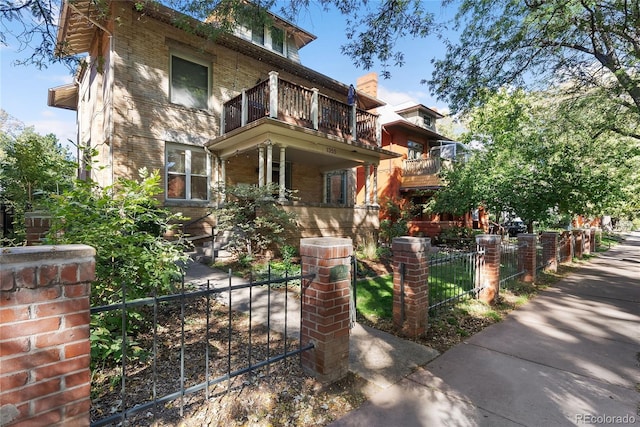1355 N Franklin St Unit 5, Denver, CO 80218 - view of front of house with a balcony, a fenced front yard, and a gate