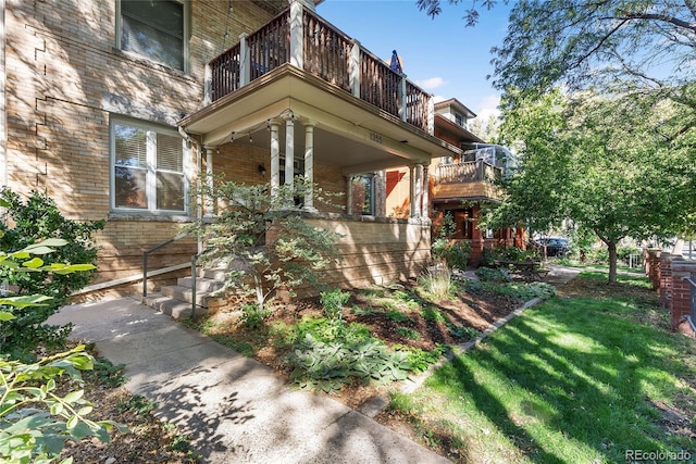 1355 N Franklin St Unit 5, Denver, CO 80218 - view of side of home featuring a balcony, brick siding, and covered porch