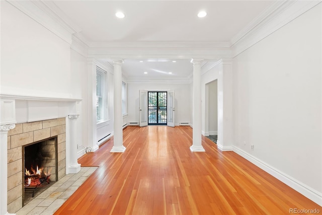 1355 N Franklin St Unit 5, Denver, CO 80218 - unfurnished living room with decorative columns, a tile fireplace, baseboard heating, light wood-type flooring, and ornamental molding