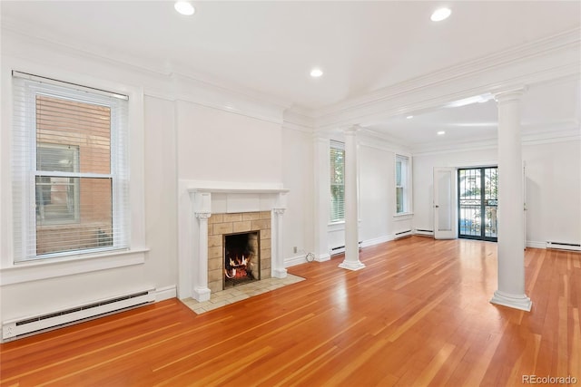 1355 N Franklin St Unit 5, Denver, CO 80218 - unfurnished living room with a baseboard heating unit, ornate columns, a tile fireplace, ornamental molding, and wood finished floors