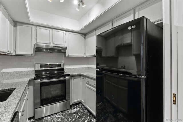 1355 N Franklin St Unit 5, Denver, CO 80218 - kitchen featuring freestanding refrigerator, stainless steel range with electric stovetop, under cabinet range hood, dark marble finish floors, and decorative backsplash