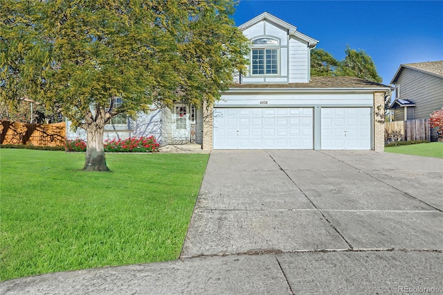 view of front of property featuring a front yard and a garage