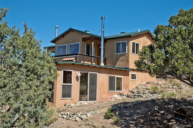 4417 Twinview Ct, Crestone, CO 81131 - rear view of property featuring stucco siding and a balcony