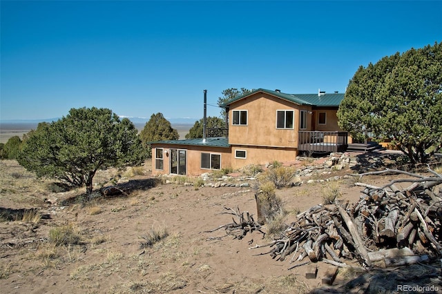 4417 Twinview Ct, Crestone, CO 81131 - rear view of property with metal roof, a deck, and stucco siding