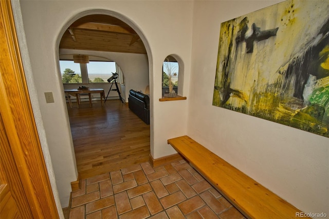 4417 Twinview Ct, Crestone, CO 81131 - hallway with arched walkways, brick floors, and beamed ceiling
