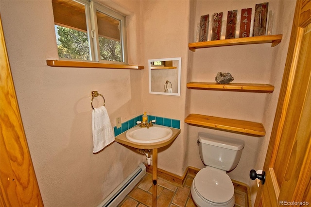 4417 Twinview Ct, Crestone, CO 81131 - bathroom with toilet, baseboard heating, a sink, tile patterned flooring, and baseboards