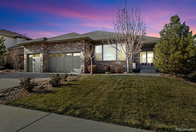 view of front of house featuring a lawn and a garage