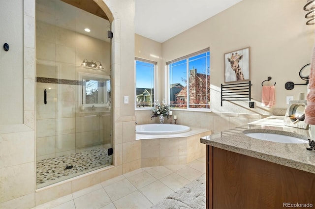 bathroom featuring tile patterned floors, vanity, and plus walk in shower