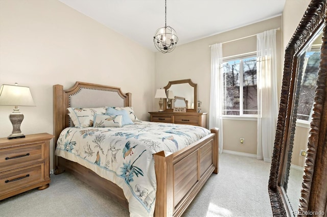 bedroom featuring light colored carpet and an inviting chandelier