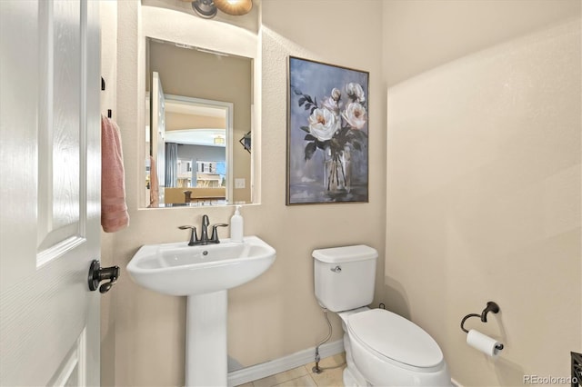 bathroom featuring sink, tile patterned flooring, and toilet