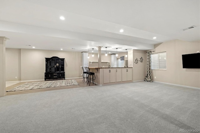 unfurnished living room with light colored carpet