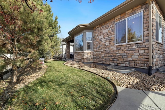 view of side of property with a lawn